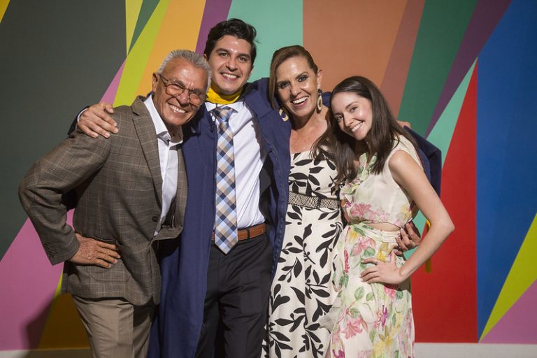 Celebrates my graduation with loved ones; their support made this milestone at the vibrant wall truly special for me.