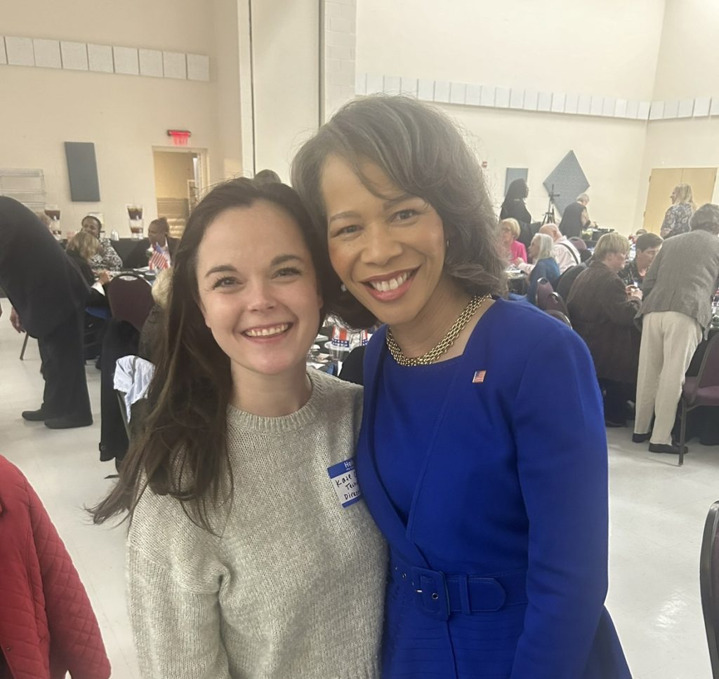 This event photo captures a joyful moment with my close friend, sharing laughs together among familiar faces in the background.