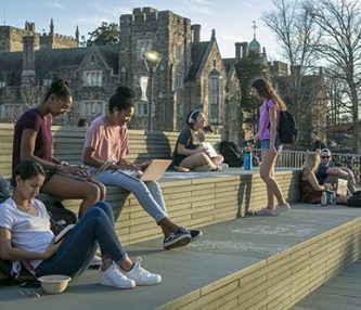 Duke students enjoy a warm and sunny February afternoon studying and socializing on the Bryan Center Plaza. From left are Isabella Jimenez, sophomore, Sydney Morrow, sophomore, and Kianna Lawrence, junior.